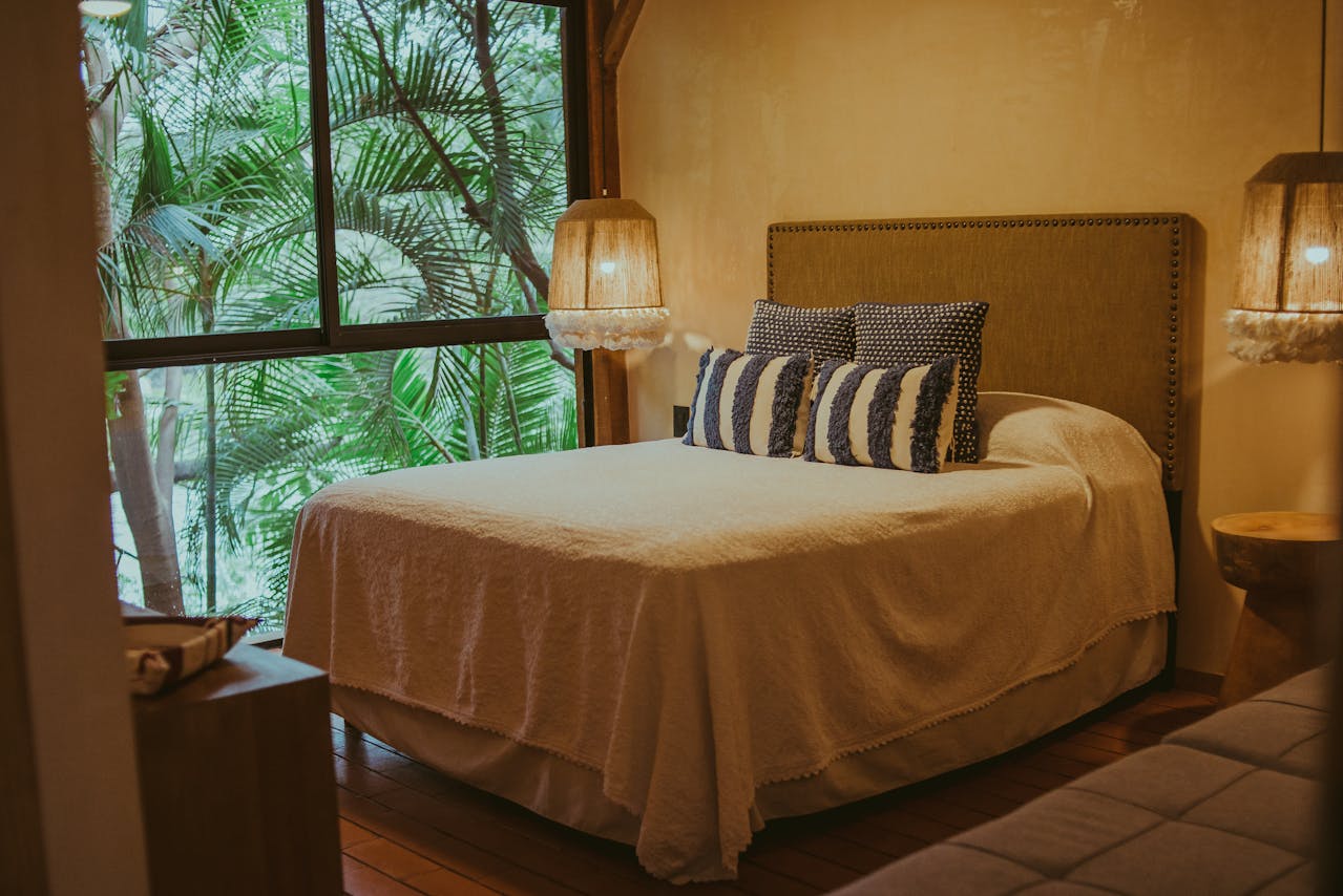 bedroom-warm-tone-covers-on-bed-palm-strees-outside bedroom-warm-tone-covers-on-bed-palm-strees-outside
