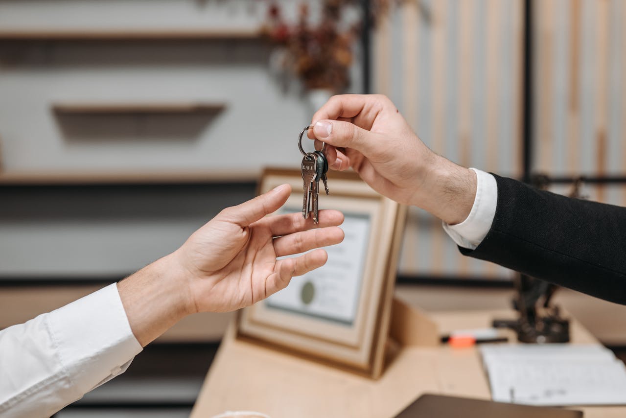 one-person-handing-keys-to-another-person
