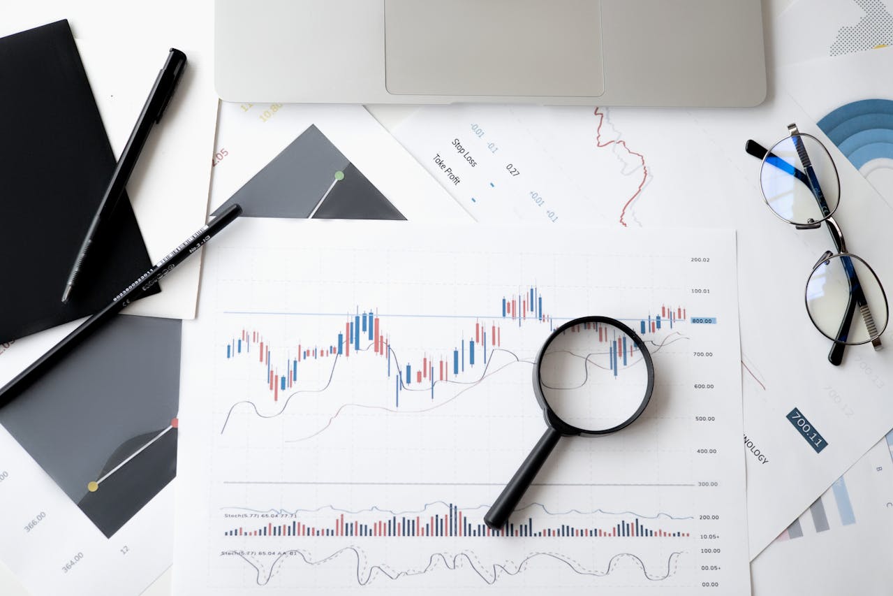 graphs-on-paper-with-magnifying-glass-over-top graphs-on-paper-with-magnifying-glass-over-top